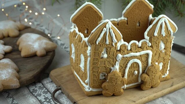Gingerbread house Christmas homemade baking. Gingerbread Man. astle with white icing. Cookies in the shape of a Christmas tree and snowflakes on the table. Food for dessert. Winter gingerbread.