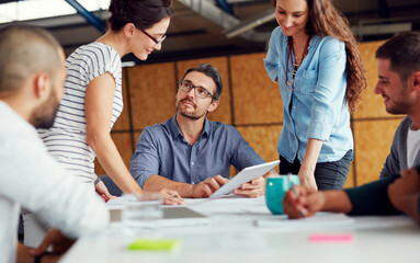 Making tomorrows success today. Shot of a group of coworkers having a meeting in an open plan office.