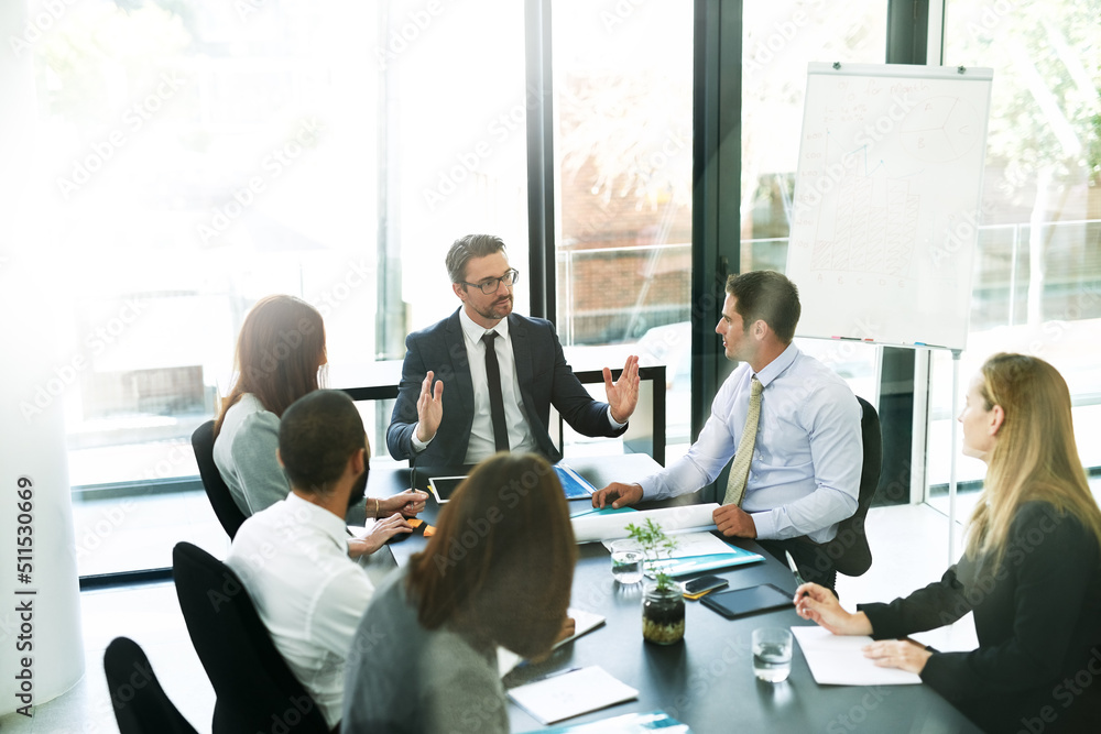 Poster working through the meeting agenda like pros. shot of a team of executives having a formal meeting i