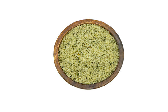 Hemp seeds in wooden bowl isolated on white background top view