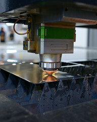 Laser machine cutting metal sheet, sparks coming