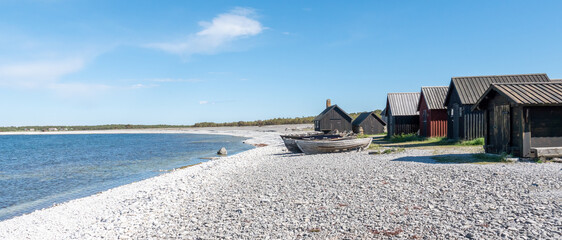 Fishermans cabin in a row by the sea. Huts on the island of Gotland in Sweden