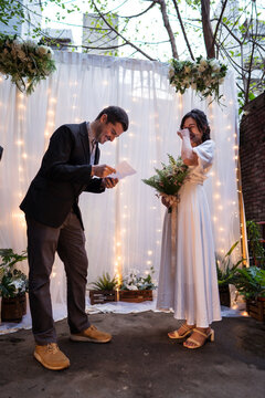Groom reading vows during wedding ceremony