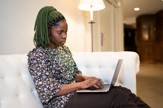 Black woman working on laptop at home