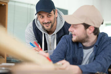 carpenter with apprentice in training period