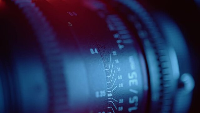Cine lens focusing close up. Macro shot of professional camcorder with focus and aperture ring. Concept of cinema or movie shooting and video production