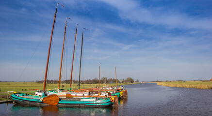 Traditional wooden sailing ships in the canal in Sloten, Netherlands