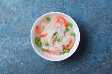 A traditional dish of Asian cuisine. Rice vermicelli with shrimps and green peas