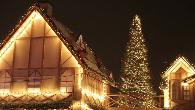 European Christmas Village Fairs. Christmas tree lights up in the evening.