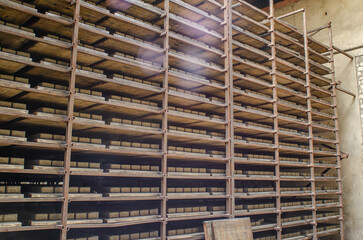 Shelving with cobblestones. Warehouse at the factory. Production of paving slabs.