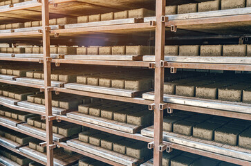 Warehouse at the factory. Production of paving slabs. Shelving with cobblestones.