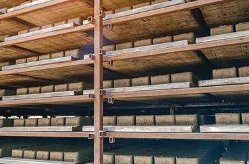 Side view of paving slabs drying on factory shelves. Production background.