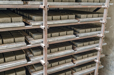 Side view of paving slabs drying on factory shelves. Production background.