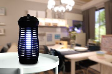 an insects mosquito electric blue light killer lamp is put on the white metal table in the nice living room to protect the mosquito during relax time