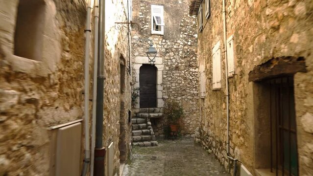 Medieval fortified village of Saint-Paul-de-Vence.
Empty narrow street in the south of France. Window openings and doors are decorated with decorative trim in St. Paul de Vence. Colorful old street
