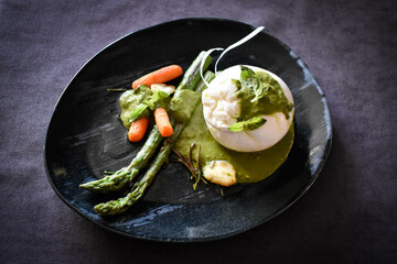 Burrata on pesto sauce with asparagus and carrots