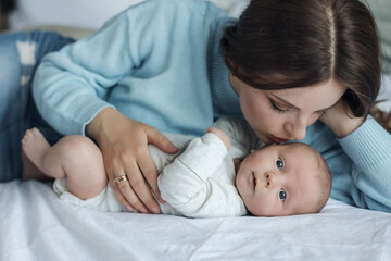 happy mother with little cute newborn at home