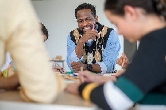 group of students studying and playing with teacher, education and learning concept.