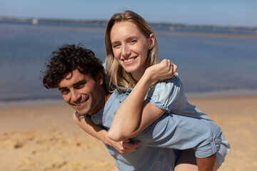 happy young couple having fun on the beach