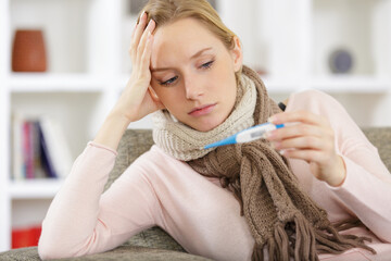 a sick woman with a thermometer