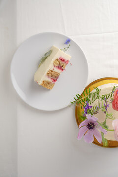 One slice of cake with whipped cream on light plate on the table