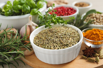 Different herbs and spices on wooden table, closeup