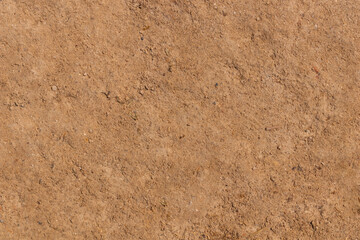 Arid sandy soil with many small stones can be used as a background or fertility and geology. - obrazy, fototapety, plakaty