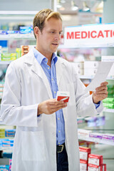 Having a look at the prescription. A pharmacist reading a prescription.