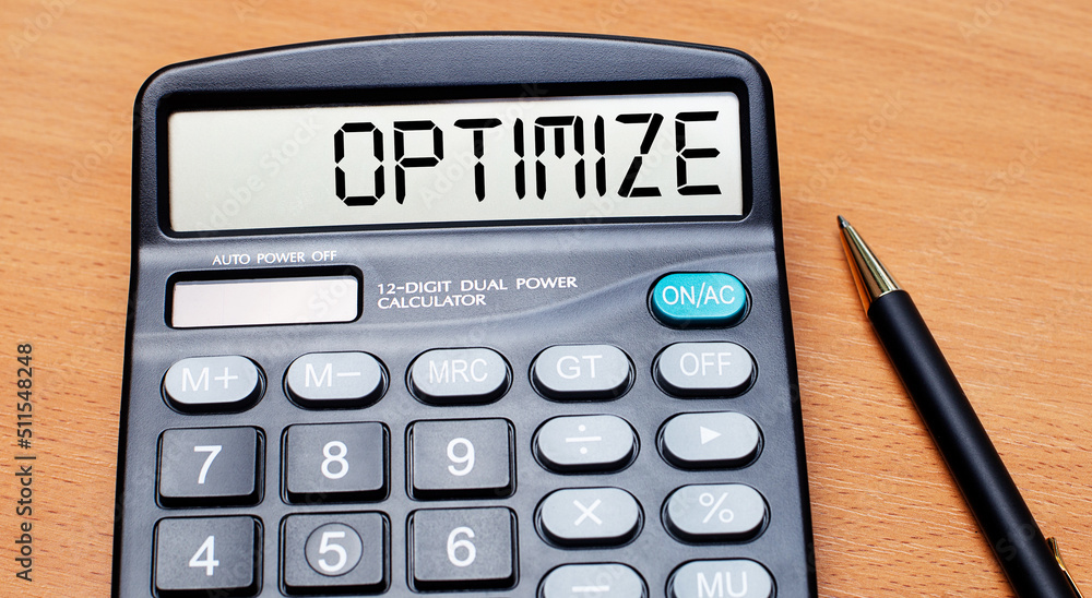 Poster on a wooden table there is a black pen and a calculator with the text optimize. business concept