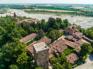 Fototapeta na wymiar Aerial view of Rivalta castle on the Trebbia river, Piacenza province, Emilia-Romagna, Italy. 06-16-2022 It is an imposing fortified complex with a cylindrical tower