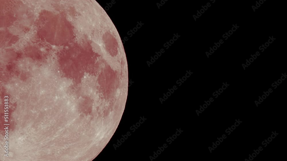 Wall mural full red moon moves fast at night sky. sharp footage of full moon with telephoto lens close-up. pink