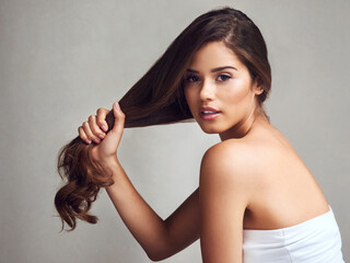 My hair regime has made my hair stronger. Studio shot of a young beautiful woman with long gorgeous...