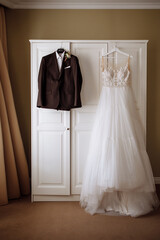 White wedding dress of the bride, shoes, suit of the groom.