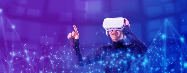 Asian woman wearing VR headset for entertainment in the metaverse. Augmented reality. Future digital technology game and entertainment. Metaverse technology concept.  - obrazy, fototapety, plakaty