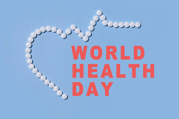 Naklejka premium Group of white round pills forms heart figure next to heart rhythms from white pills on a blue background. Theme of health care, medical treatment and disease prevention.