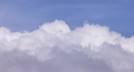 View of Cloudscape during a cloudy blue sky sunny day. Taken on the West Coast of British Columbia, Canada.
