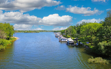 Obraz premium Beautiful scenic dutch lake, yacht harbour, green forest, blue summer sky - Leukermeer, Netherlands