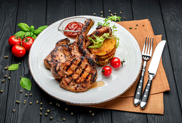 Pork steak with bone and potato pancakes