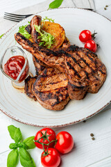 Pork steak with bone and potato pancakes