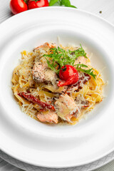 Italian pasta with salmon, cheese and tomatoes