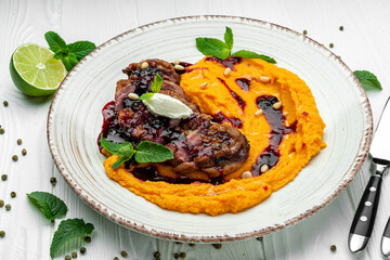 Duck fillet in cherry sauce with pumpkin puree