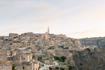 Fototapeta na wymiar Stunning view of the village of Matera during a beautiful sunrise. Matera is a city on a rocky outcrop in the region of Basilicata, in southern Italy.