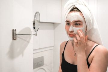 Beauty concept. Wellness, taking care yourself. Portrait beautiful woman looking in the mirror in...