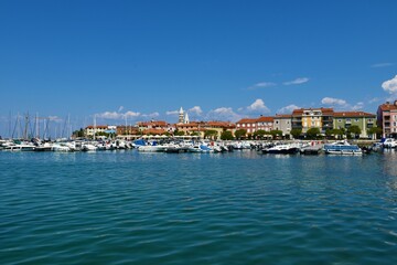 Naklejka na ściany i meble Izola, Slovenia - May 10 2022: Harbour and the town of Izola in Istria, Slovenia