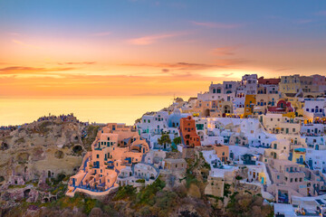 Fototapeta premium Oia town on Santorini island, Greece. Traditional and famous houses and churches with blue domes over the Caldera, Aegean sea