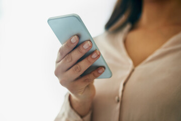 The smarter side of communication. Closeup shot of an unidentifiable businesswoman using a cellphone in an office.