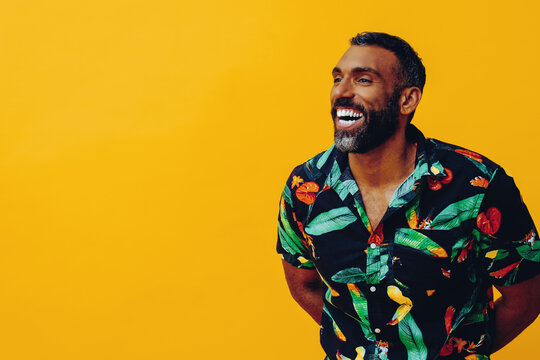 Fototapeta happy smiling african american man wearing Hawaiian shirt looking away at copy space mid adult studio shot