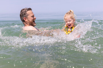 Father and daughter swimming in Lake Michigan at the Indiana Dunes National Park NPS