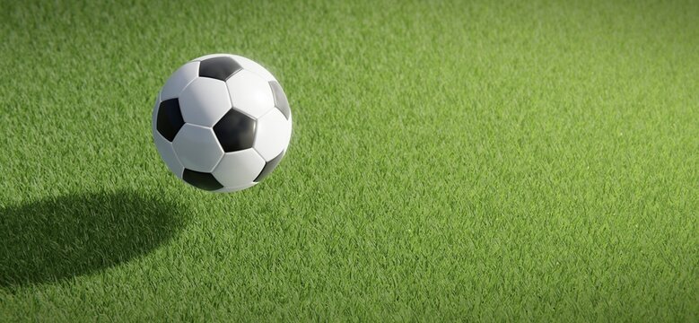 Classic football or soccer ball floating against grass pitch backdrop.