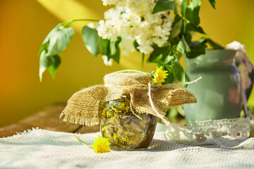 Natural organic tincture with fresh yellow wildflowers - dandelions. Homemade homeopathy...